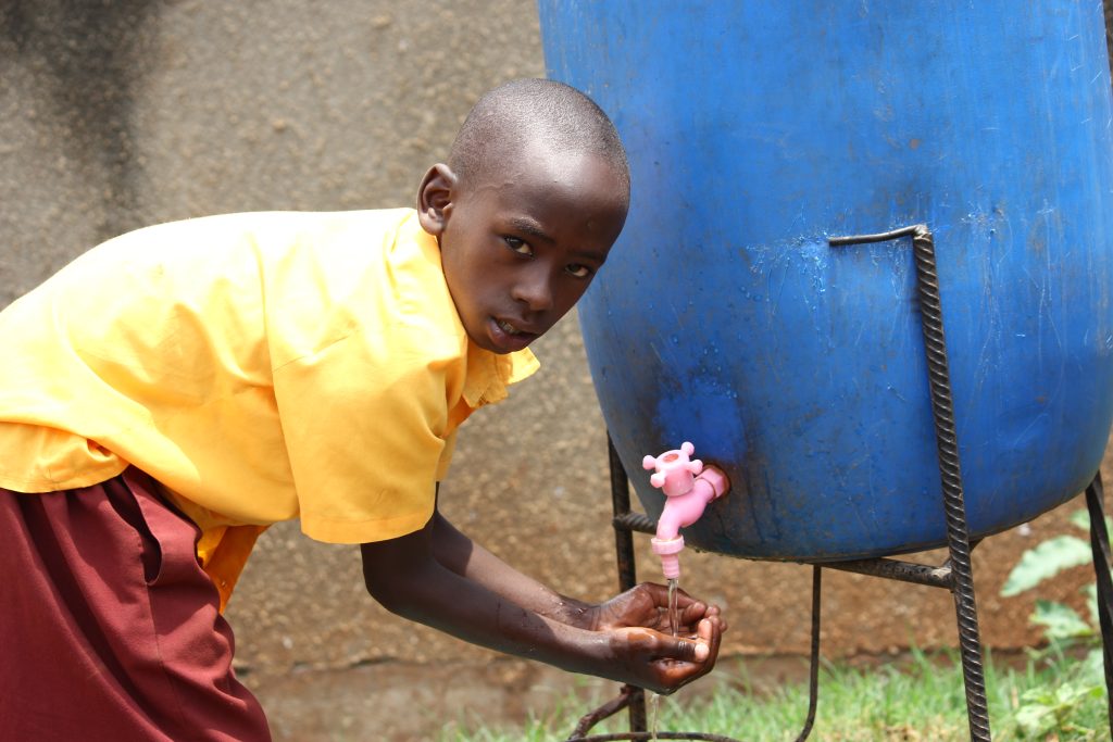Schoolboy at water point - Kampala